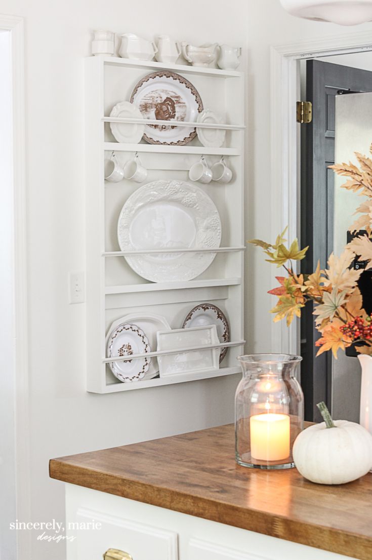 a kitchen counter with plates and candles on it