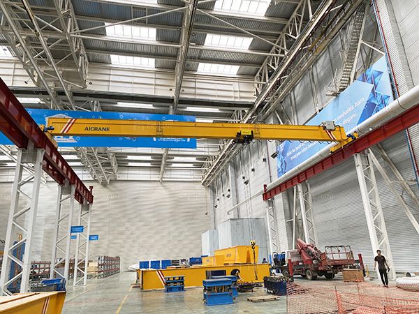 the inside of a large warehouse with lots of steel beams and overhead lights on it