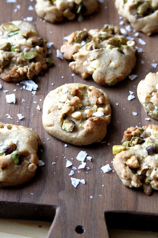 several cookies are on a wooden tray with white flakes