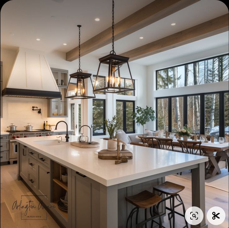 a large kitchen with an island in the middle and lots of windows on both sides