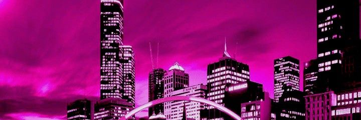 the city skyline is lit up in pink and purple with an arch at the end