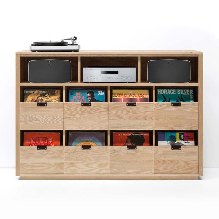 an entertainment center with many books and speakers