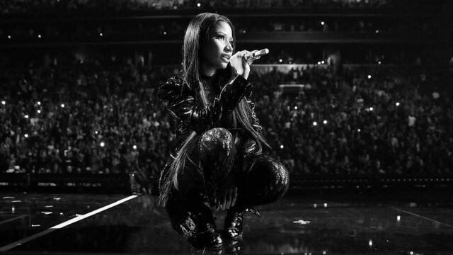 a woman standing on top of a stage holding a microphone