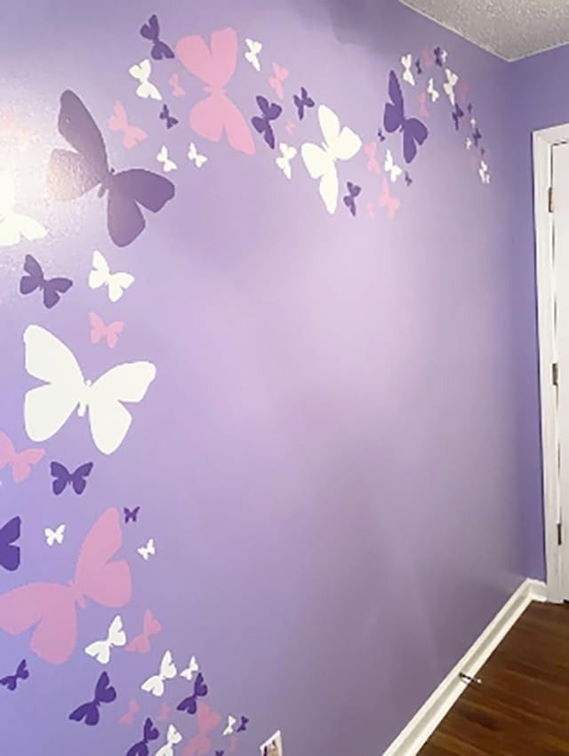 a room with purple and white butterflies painted on the wall