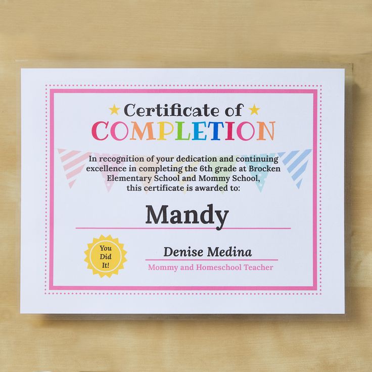 a certificate is displayed on a wooden surface