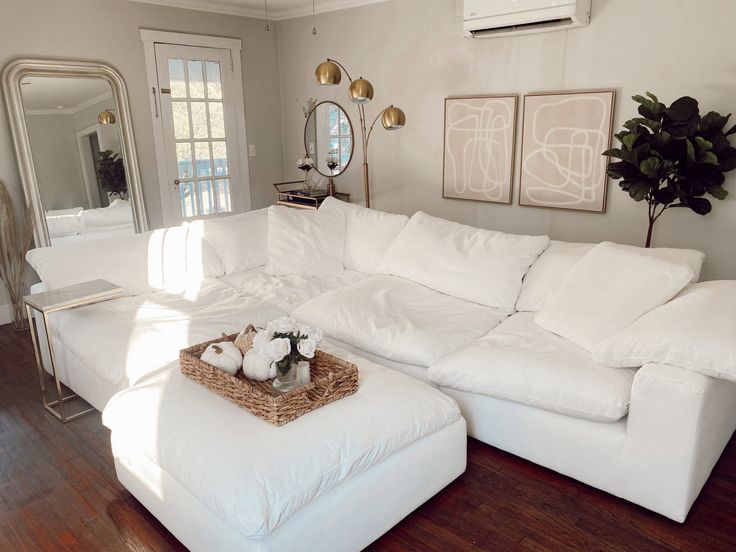 a large white sectional couch in a living room