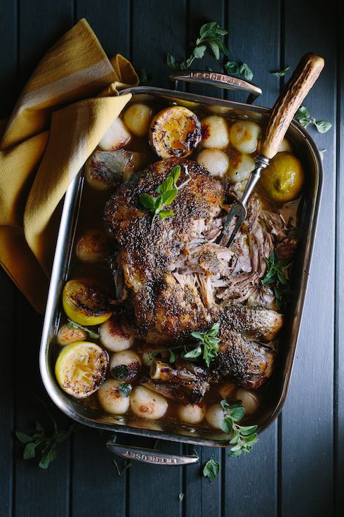 a roasting pan filled with meat and potatoes