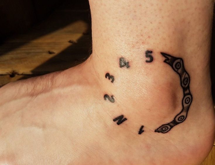 a small tattoo on the foot of a person