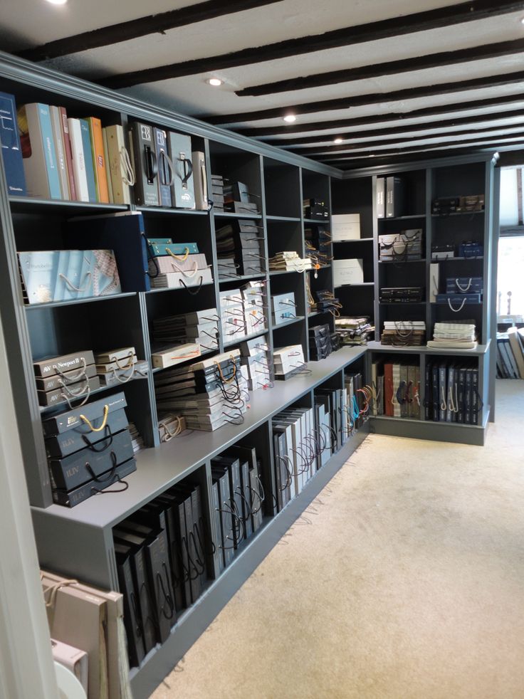 a room filled with lots of books on shelves next to a wall full of folders