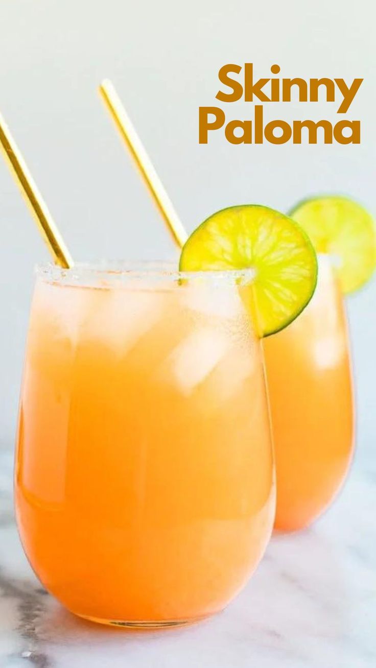 two glasses filled with orange juice and garnished with lime