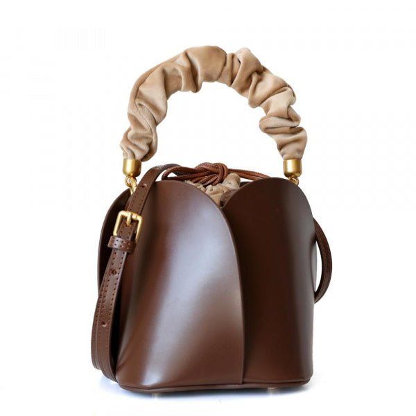 SO Unique! Tulip Leather bag offers a fresh take on the timeless bucket design, breaking through with a four-bladed body and a frilled handle to top off in unmistakable fashion.Wear it both on the shoulder or by hand as you stroll through the next season with ease. Beautiful crossbody comes with 3 changeable handles!Dimensions: 7" x 7" x 5.5"Materials: Genuine Leather Bucket Handbags, Flower Bucket, Mini Bucket Bags, Lv Bags, Brown Handbag, Leather Flowers, Caramel Color, Leather Bucket Bag, Leather Bucket