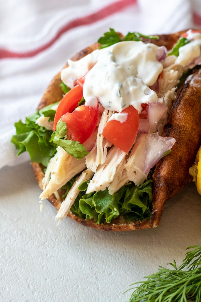 an easy chicken gyro sandwich with lettuce, tomatoes and mayonnaise