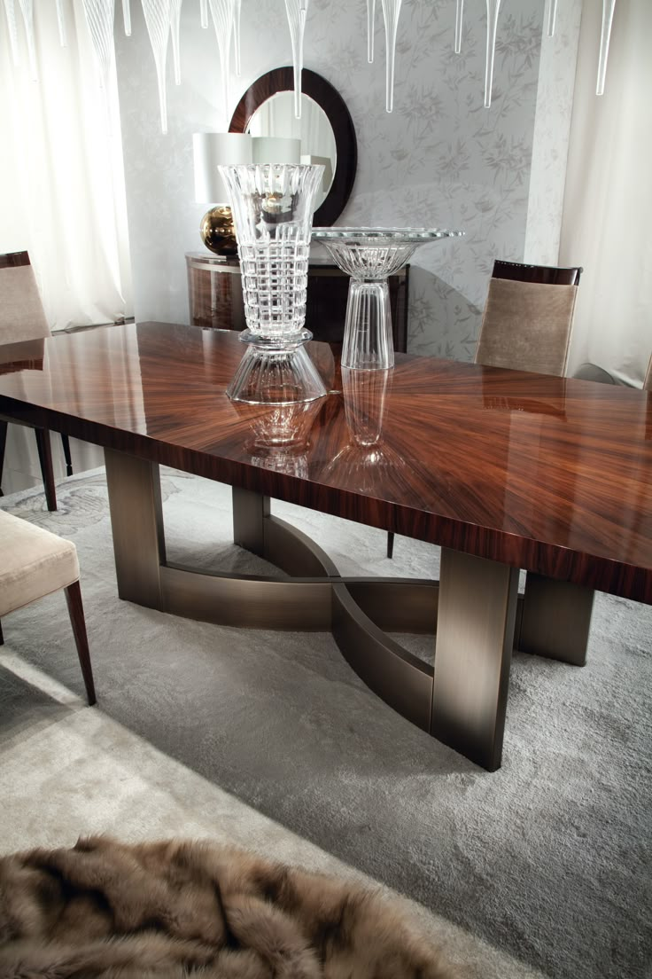 an elegant dining table with glass vases on it