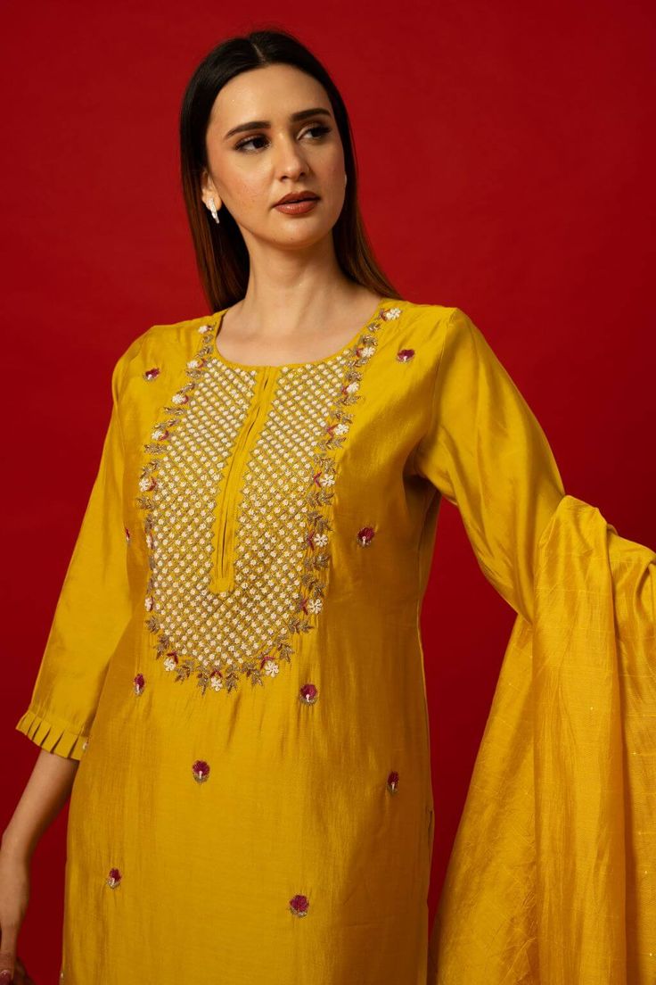 Elevate your wardrobe with the Yellow Silk Kurti Set. This set stands out with its intricate embroidery work. It transcends seasonal trends, offering versatility for various occasions. Whether it's a family gathering, festive celebration, or formal event, the Yellow Silk Kurti Set ensures you stand out with elegance. Its timeless appeal guarantees it as a cherished piece in your collection for years to come. Festive Cotton Silk Dress With Floral Embroidery, Embroidered Slub Silk Kurta For Wedding, Embroidered Raw Silk Palazzo Set For Festivals, Diwali Palazzo Set With Floral Embroidery And Straight Kurta, Floral Embroidered Palazzo Set With Straight Kurta For Diwali, Traditional Slub Silk Palazzo Set With Resham Embroidery, Embroidered Raw Silk Palazzo Set With Traditional Drape, Embroidered Raw Silk Palazzo Set, Festive Embroidered Slub Silk Palazzo Set