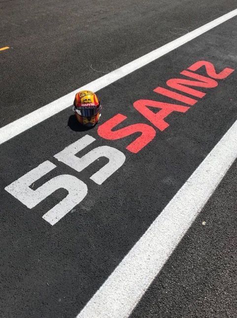 a helmet sitting on the side of a race track