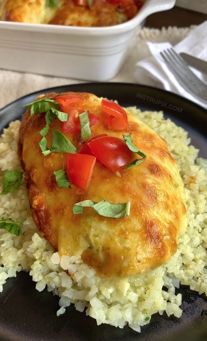 a black plate topped with rice and veggies