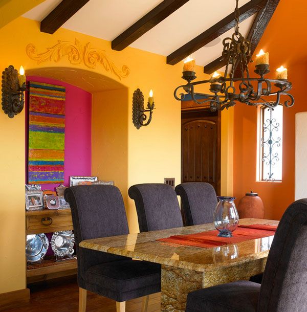 a dining room table with chairs and a chandelier hanging from it's ceiling