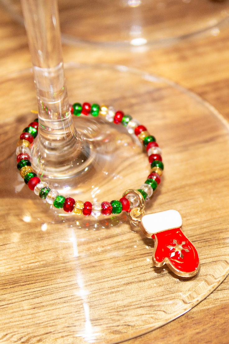 a wine glass with a beaded bracelet on it