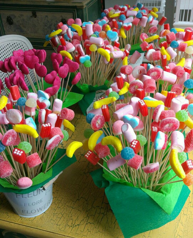 a table topped with lots of fake candy lollipops