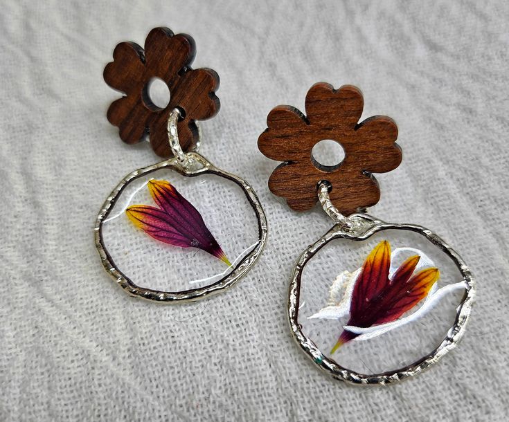 Welcome to my shop where nature meets art in these beautiful Resin Flower Red Wood Earrings. Made with real Oklahoma Blanket Flowers, these earrings are a unique and stunning addition to any jewelry collection. - Handmade with love and attention to detail - Lightweight and comfortable to wear all day - Each pair is one-of-a-kind, just like you Don't miss out on adding these gorgeous earrings to your collection. Order now and bring a piece of nature with you wherever you go! Unique Flower Shaped Earrings As Gift, Unique Flower Jewelry, Handmade Flower Earrings As Gift For Her, Unique Flower Earrings As Gift, Unique Pierced Flower Earrings As A Gift, Nickel Free Botanical Earrings As Gift, Unique Flower Earrings For Gifts, Nickel Free Botanical Earrings For Gifts, Unique Flower Earrings For Pierced Ears As Gift