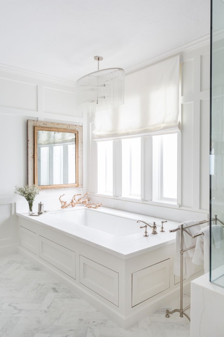 a white bath tub sitting next to a window