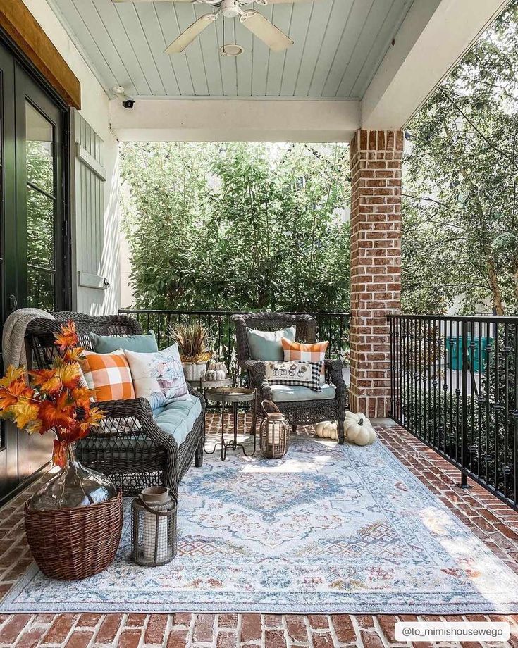 an outdoor patio with furniture and flowers on the rug