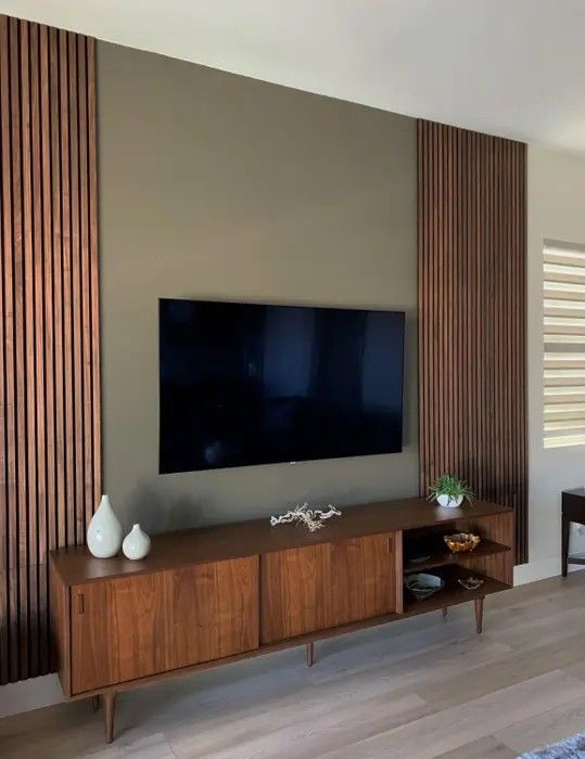 a large flat screen tv mounted to the side of a wall in a living room