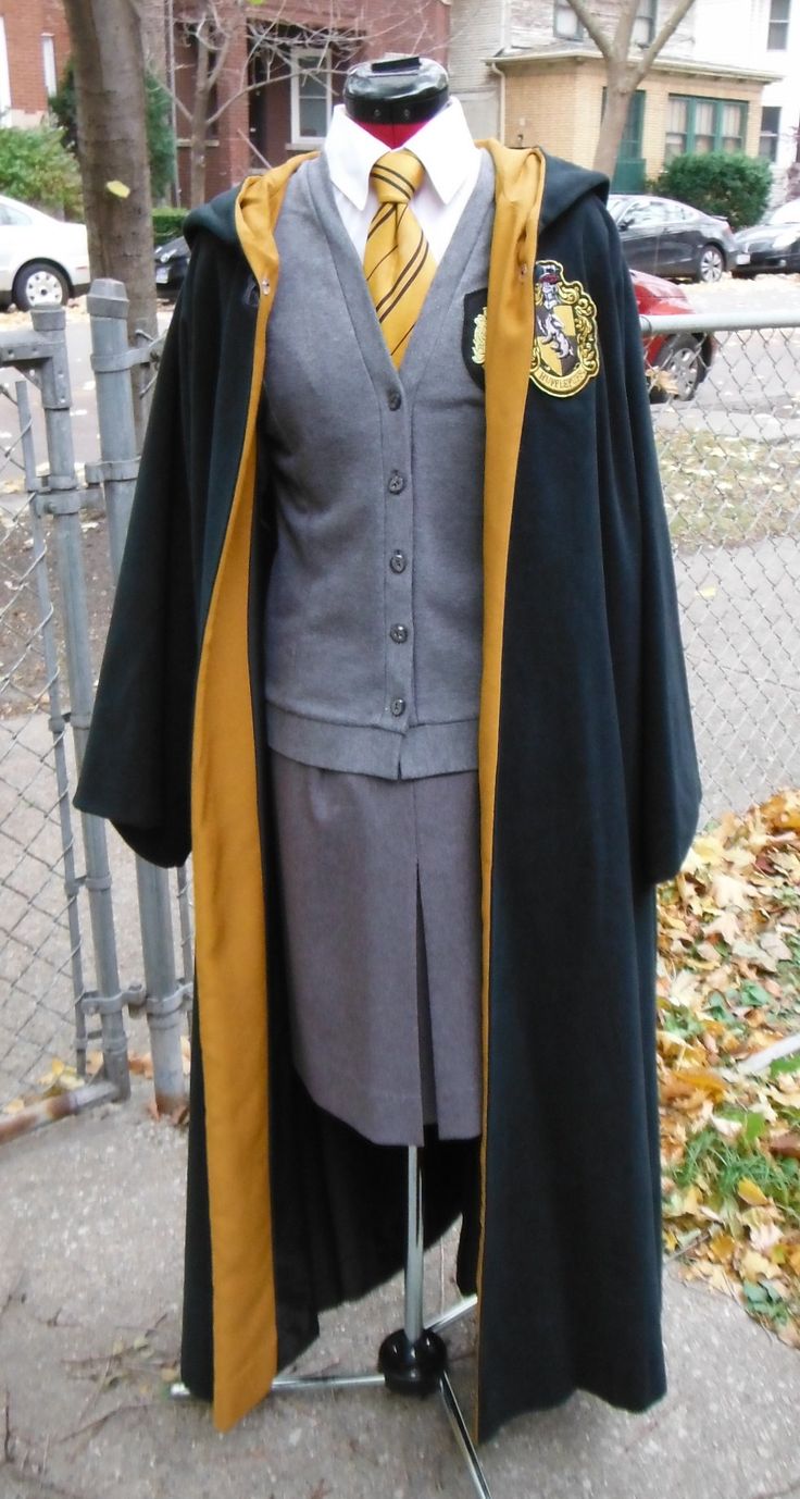 a harry potter costume on display in front of a fence