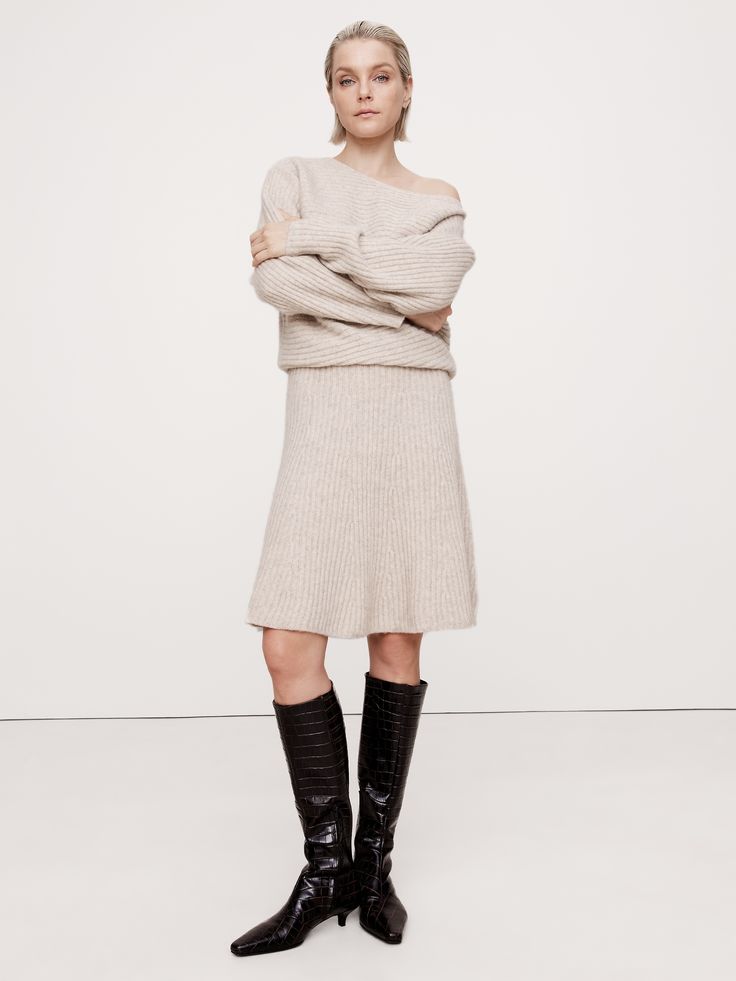 This sweater dress beautifully demonstrates the power of texture, using a mix of diagonal and vertical ribbed knit stitches to emphasize the luxurious handfeel of its wool-blend fabric.  Here, we knitted this mini dress using one of our warmest wool-blend yarns, one we selected for its softness and subtle, bouclé texture.  Relaxed fit with defined waist, flare skirt.  Boat neck.  Pull-on design.  Unlined.  Relaxed fit with defined waist, flare skirt.  Long sleeves.  Mini length.  Model: Size S, Elegant Knee-length Cable Knit Sweater Dress, Elegant Chunky Knit Sweater Dress, Chic Cable Knit Mini Dress, Extra Dresses, Mini Sweater, Defined Waist, Knit Stitches, Flared Mini Skirt, Outfit Inspiration Fall