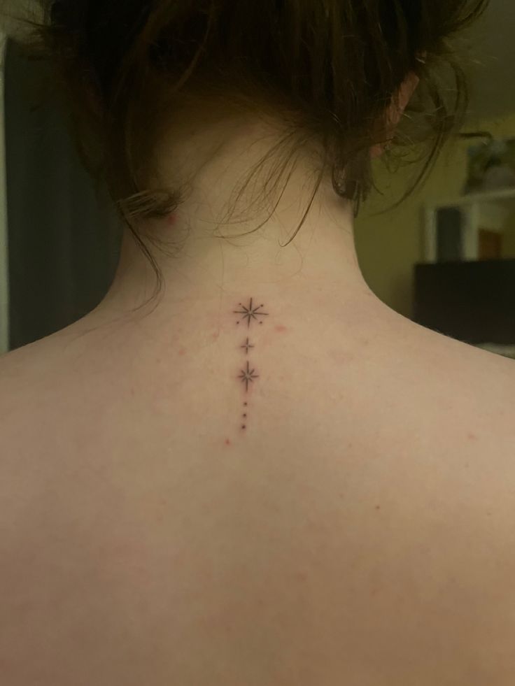 a woman with a cross tattoo on her back