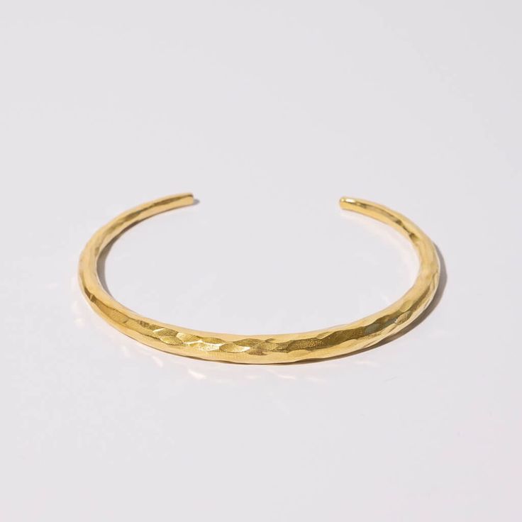 Made with 100% Brass and 100% Sterling Silver One size 2.75"D 0.25" Band Width at its widest point Handcrafted in Nepal This cuff bangle wraps your wrist elegantly. Wear alone or layered with other bracelets to create your own look. A true statement piece that is finished with a hammering technique that makes each piece completely unique. *Made entirely by hand, slight variations make each piece truly one of a kind Care: Metals will tarnish as they respond to moisture and individual body chemist Elegant Hammered Adjustable Cuff Bracelet, Minimalist Hammered Cuff Bangle Bracelet, Elegant Hammered Cuff Bangle, Minimalist Hammered Cuff Bracelet, Modern Hammered Cuff Bangle, Adjustable Stackable Cuff Bracelet, Modern Hammered Bangle Bracelets, Adjustable Hammered Cuff Bangle, Adjustable Hammered Cuff Bracelet