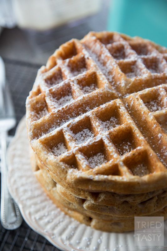 a stack of waffles sitting on top of a plate next to a fork