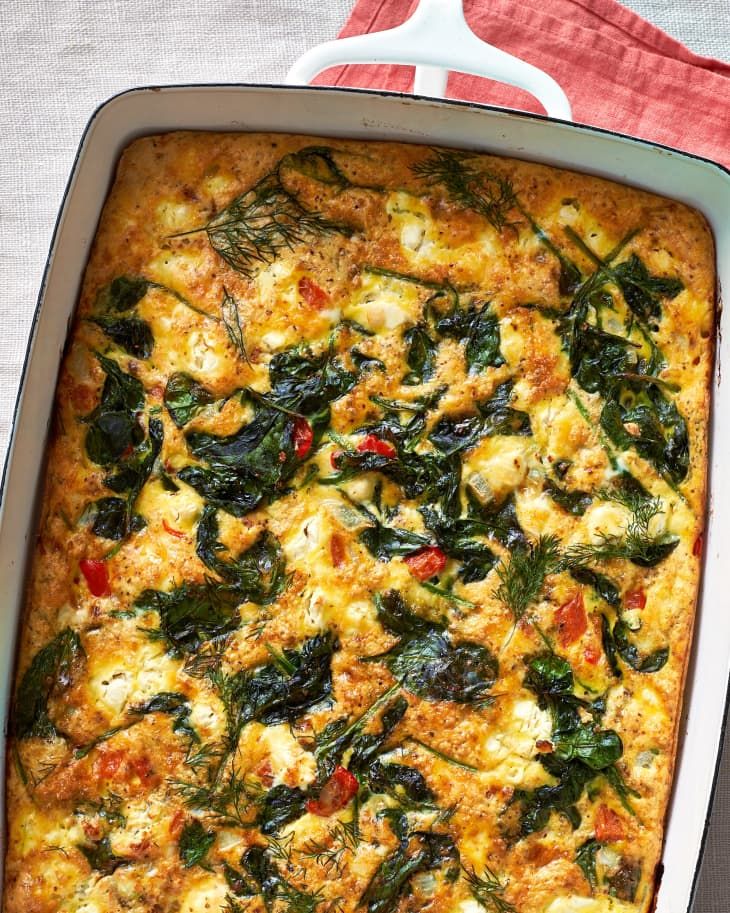 a casserole dish with spinach and cheese