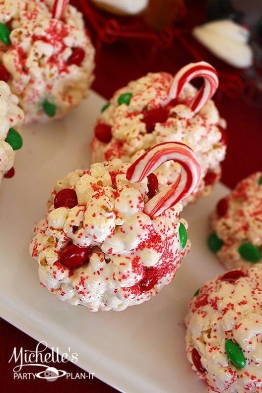 some candy canes and marshmallows are on a white platter with peppermints