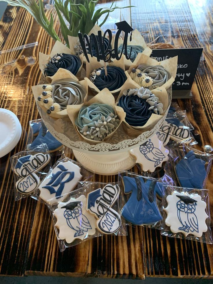 some cookies are sitting on a table with flowers in a vase and other items around it