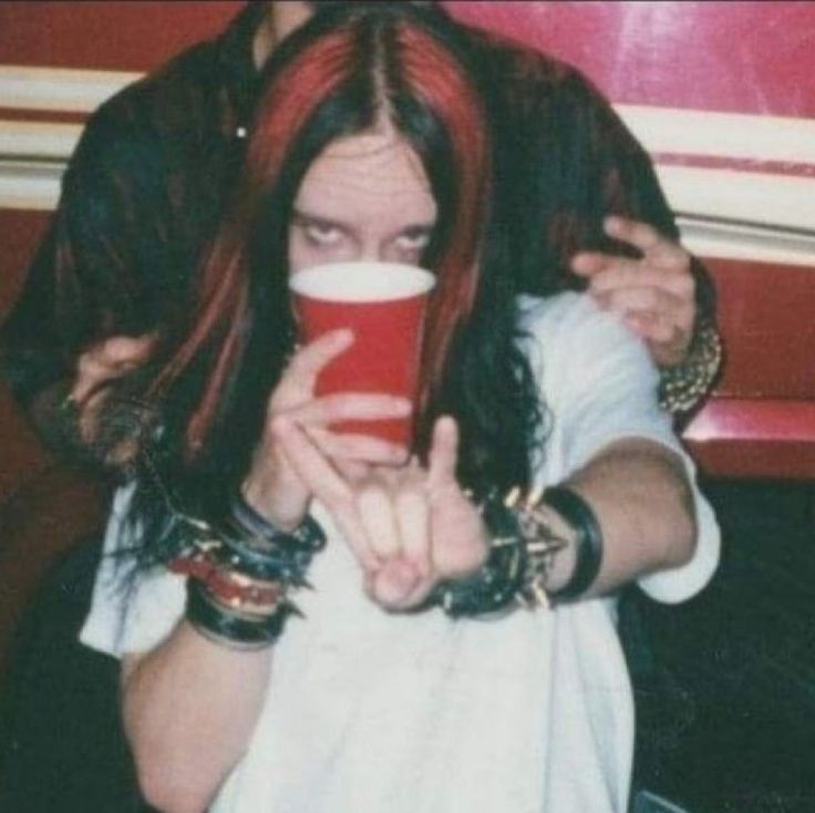 a man with red hair holding a cup in his hands