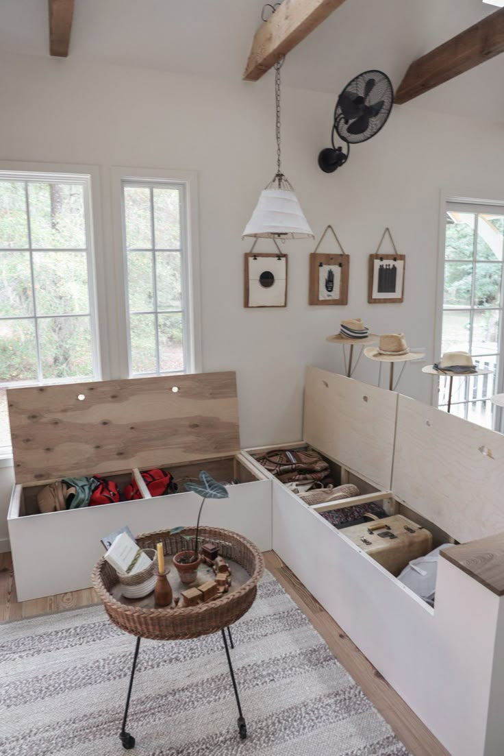 a living room filled with lots of furniture and decor on top of a wooden floor