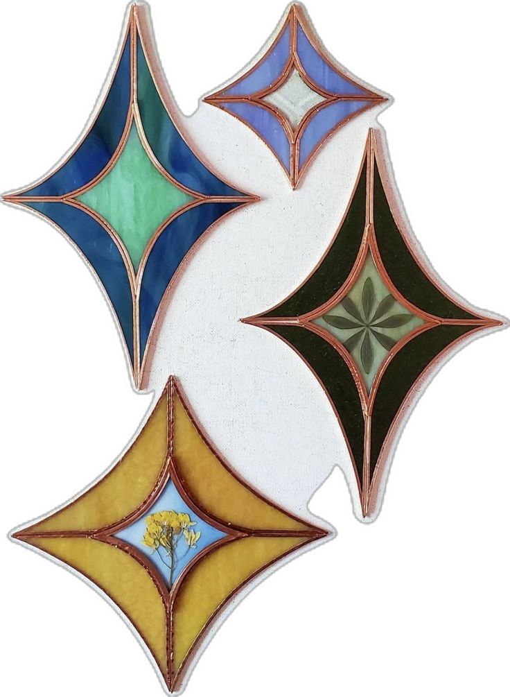 three different colored stained glass designs on a white background