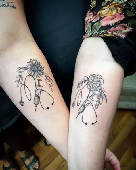 two people with matching tattoos on their arms