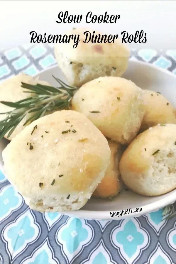 slow cooker rosemary dinner rolls in a white bowl on a blue and white tablecloth