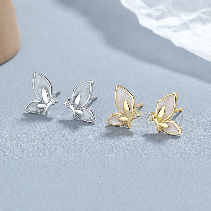 Description & Details Embrace the delicate beauty and transformative symbolism of butterflies with our exquisite pieces. Each design in our collection is meticulously crafted to capture the elegance and grace of these magnificent creatures.• Material: Solid 925 Sterling Silver ∙ Cubic Zirconia ∙ Enamel• Finish: Hypoallergenic ∙ Gold Plating• Dimensions: 9 x 8 mm each• All our work is custom made by hand with love Butterfly Stud Earrings, Butterfly Earrings Stud, Delicate Beauty, Girly Jewelry, Ear Studs, Silver Earrings Studs, Solid 925 Sterling Silver, Gold Plating, Butterflies