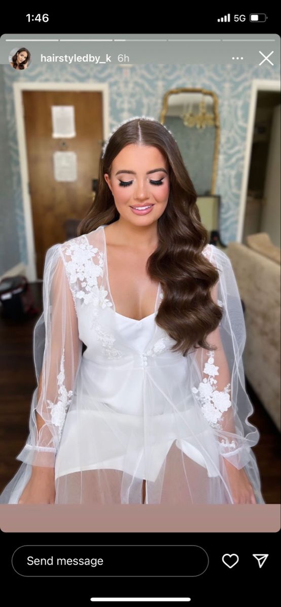 a woman with long hair wearing a white dress and veil on her head is looking at the camera