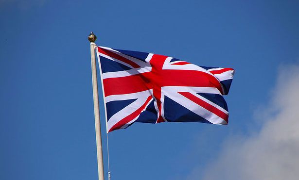 the british flag is flying high in the sky