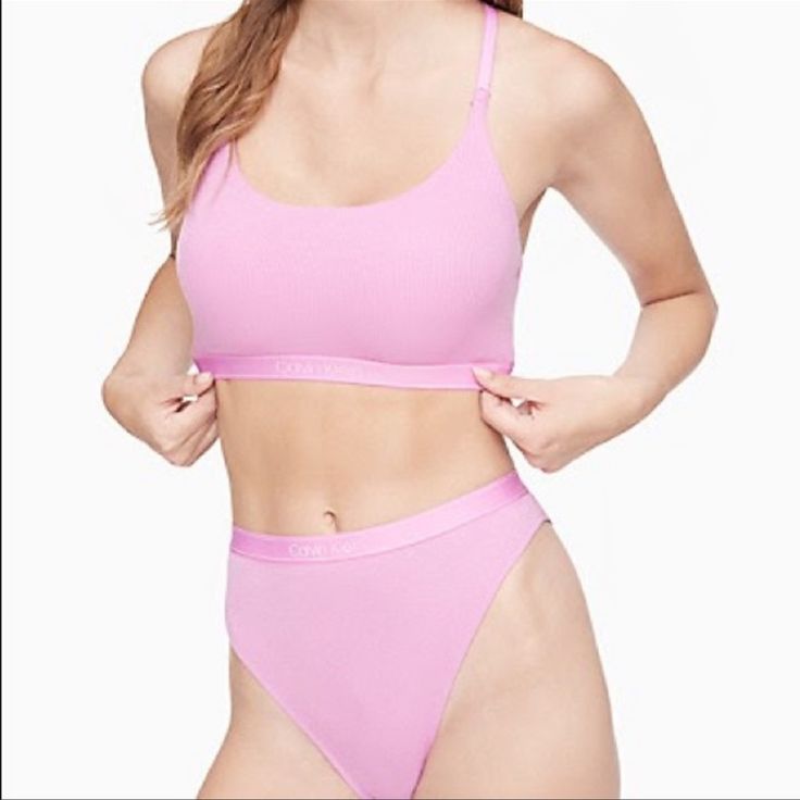 Finely Ribbed In An Ultra Soft Micro Modal Stretch Blend, This Calvin Klein Unlined Bralette Features A Signature Logo Elasticated Band. Detailed With A Scoopneck, Adjustable Straps And A Cushioned Back Closure For A Solid, Timeless Look. Finely Ribbed In An Ultra Soft Micro Modal Stretch Blend, This Calvin Klein Bikini Features A Signature Logo Elasticated Band. Detailed With A Fully Lined Gusset, Rear Coverage And Seaming Details For A Solid, Timeless Look. Calvin Klein Seamless Swimwear For Summer, Calvin Klein Seamless Swimwear For Beach, Calvin Klein Seamless Spring Bra, Spring Stretch Calvin Klein Bra, Calvin Klein Summer Swimwear Briefs, Solid Color T-back Intimate Top, Fitted Calvin Klein Bra For Summer, Calvin Klein Fitted Bra For Summer, Fitted Calvin Klein Summer Bra