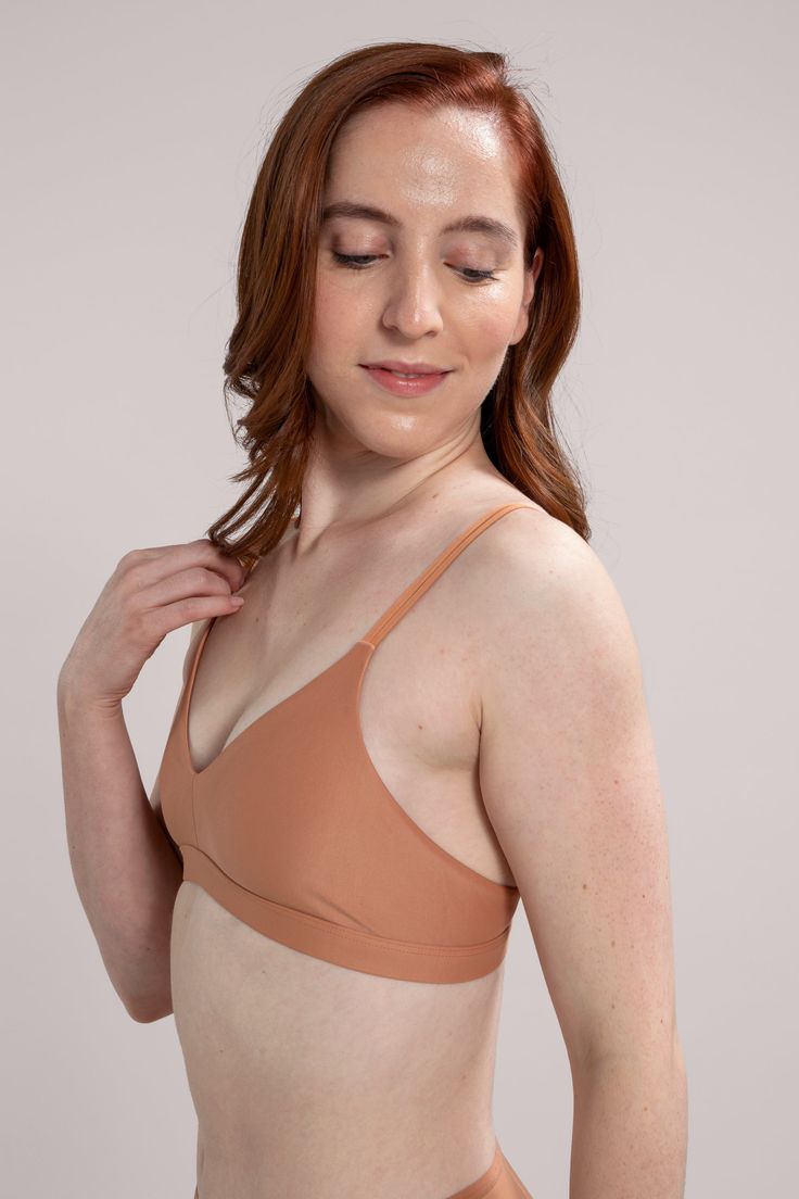 The Nude Barre bralette offers lightweight and durable support for everyday wear. Designed with ultra-soft, flexible fabric for optimal comfort and ease. Featuring a v-neckline design, our bralette is perfect for pairing with any wrap dress, t-shirt, or cami. Available in our 12 signature shades of nude. Country of Origin: Colombia Low-cut Crop Top With Built-in Bra For Loungewear, Stretch V-neck Bra With Adjustable Straps, Everyday Fitted Seamless Nursing Bra, Stretch V-neck Yoga Bra, Stretch V-neck Bra For Yoga, Everyday Nursing Bra With Removable Pads, Summer Triangle Top Bra With Light Support, Everyday Solid Bra With Adjustable Straps, Seamless No-show Nursing Bra