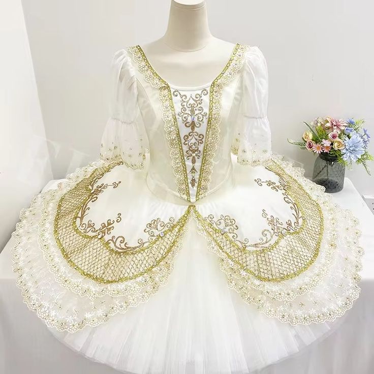 Exclusive bell-shaped tutu for Macha Grand Pas, in the ballet "The Nutcracker". This professional stage costume can also be used for the role of Aurora, Paquita, Raymonda, Cinderella, and for any other Pas de Deux. Ivory satin bodice with rich golden appliques decorations, lace, crystals and sparkles. Three quarter length white organza sleeves with decorated edges. Professional, hooped 12 layers ivory white tutu skirt with rich embellishments. Golden net, gold appliques, lace and crystals were used to make this costume a real princess tutu. Custom made. Delivery time: 6 to 8 weeks $ 900 White Fitted Tutu Dress For Costume, Ballet The Nutcracker, White Tutu Skirt, Gold Applique, White Tutu, Real Princess, Organza Sleeves, Princess Tutu, The Ballet