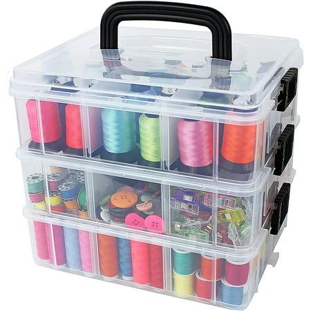 a plastic box filled with lots of spools of thread