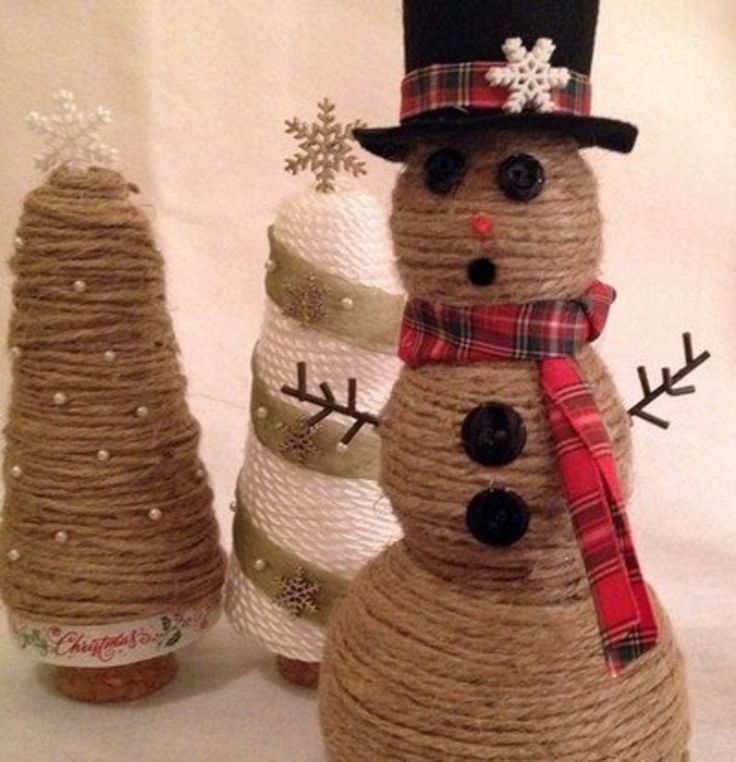 two snowmen made out of twine and burlocks, one wearing a top hat