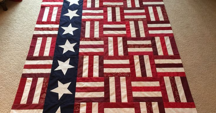 an american flag quilt is laying on the floor