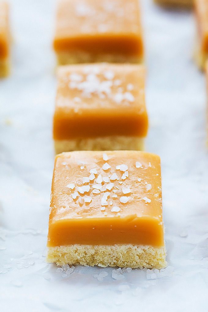 three pieces of cake sitting on top of a white tablecloth covered in sea salt